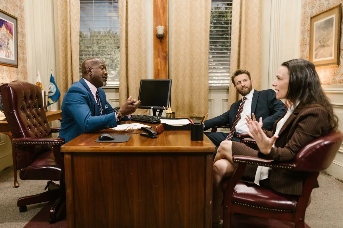 Lawyer meeting two clients in a traditional law office