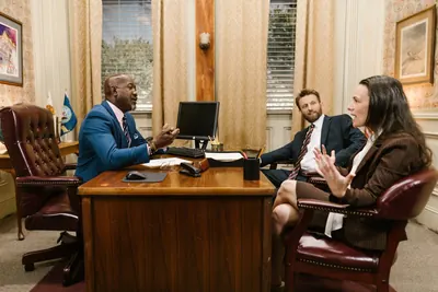 Lawyer meeting two clients in a traditional law office