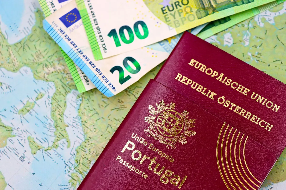 Euro banknotes and a European passport on a world map