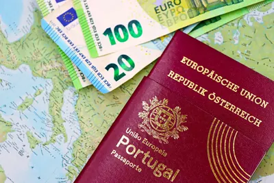 Euro banknotes and a European passport on a world map