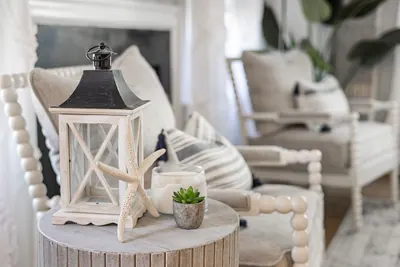 Coastal-style living room with a lantern, starfish and white furniture