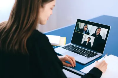Woman on a video call with colleagues on her laptop